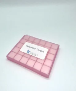 Ketamine troches in a medication container with information about their uses, benefits, and safety